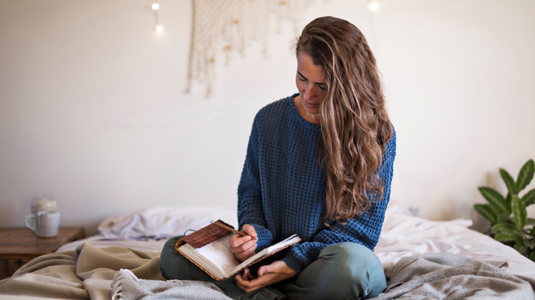 Woman writes plans in journal