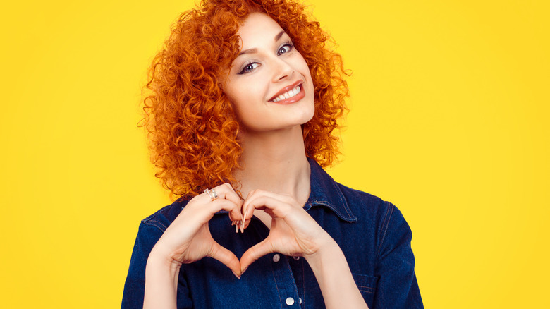 Woman making a heart gesture