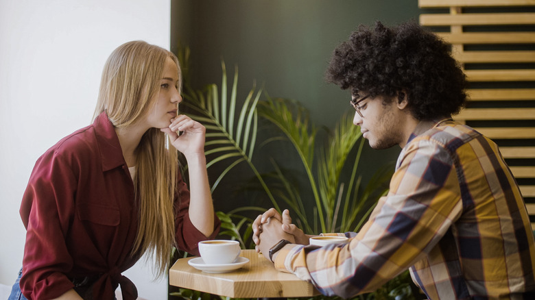 Upset couple at cafe