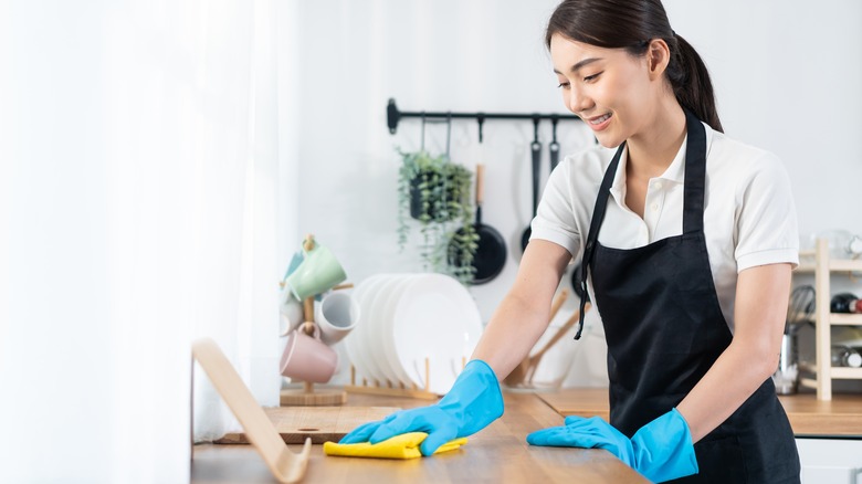 woman cleaning kitchen counter