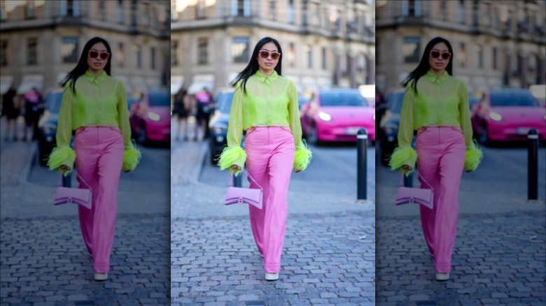 Woman wearing neon sheer top, pants