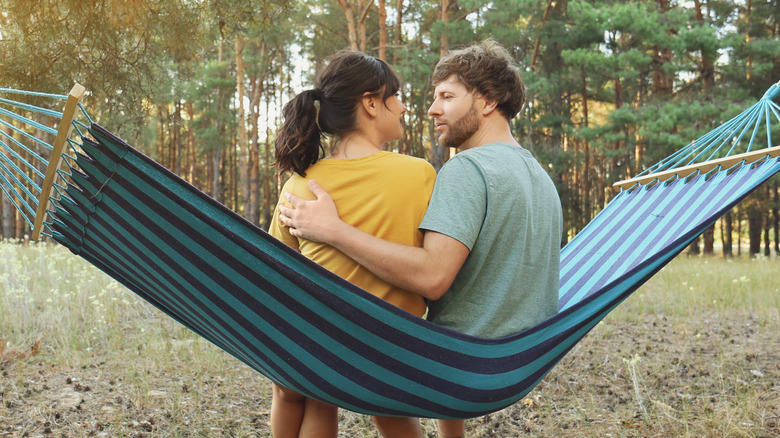 Couple sitting in hammock together