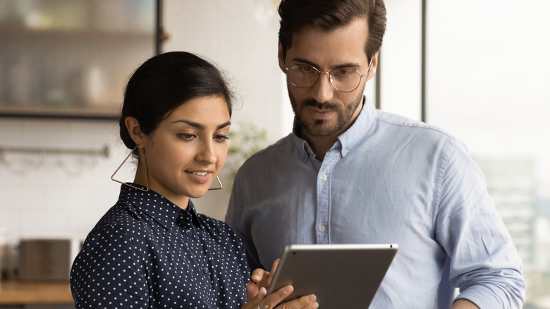 Couple looking at tablet screen together