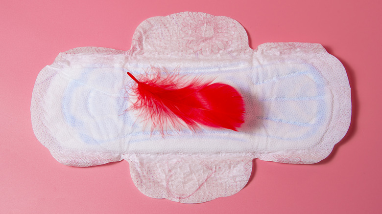 Period pad with red feather