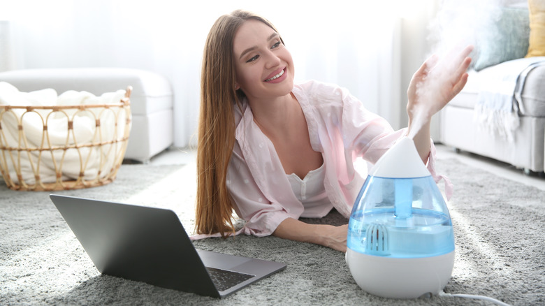 Woman working near humidifier 