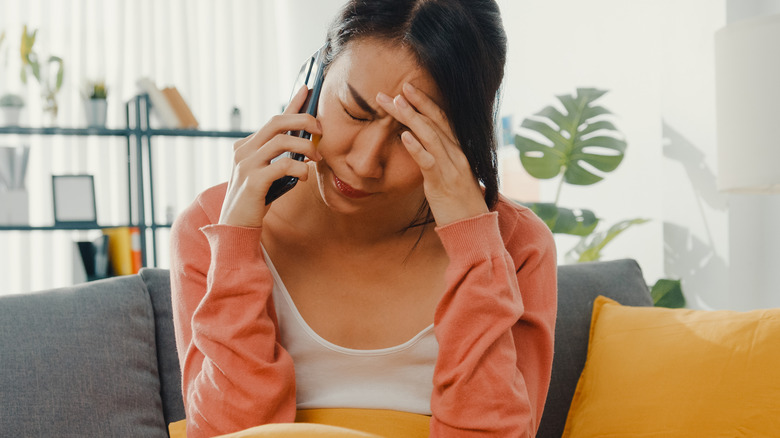 Asian woman stressed on phonecall