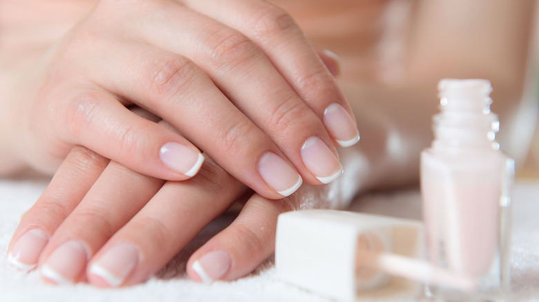 woman's hands and a bottle of polish