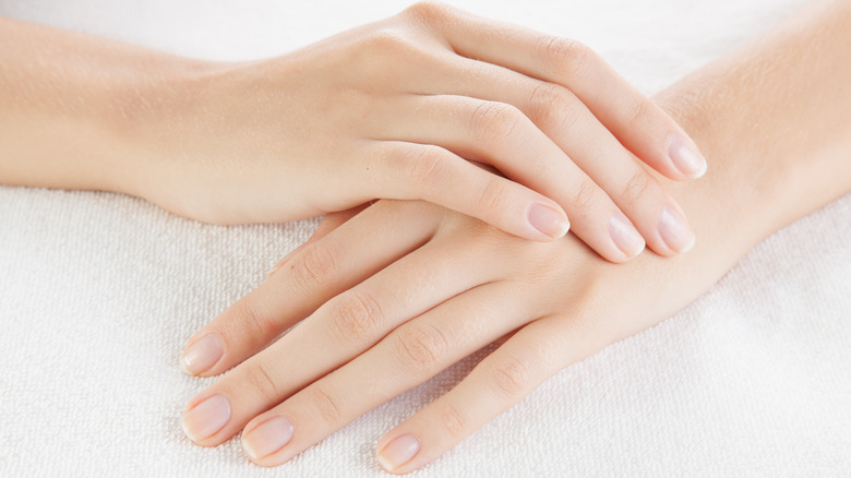 woman's hands with no nail polish