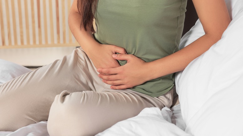 Woman in bed pelvic pain