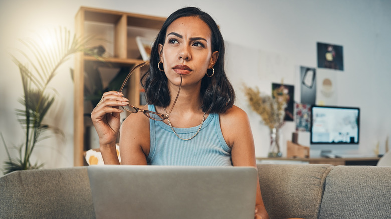 Thoughtful woman trying to decide 