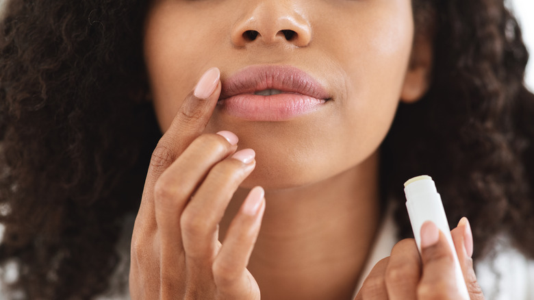 Person applying lip balm.