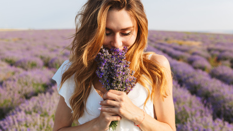 person smelling lavender