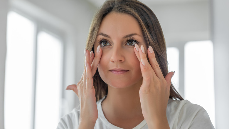 woman applying under-eye cream