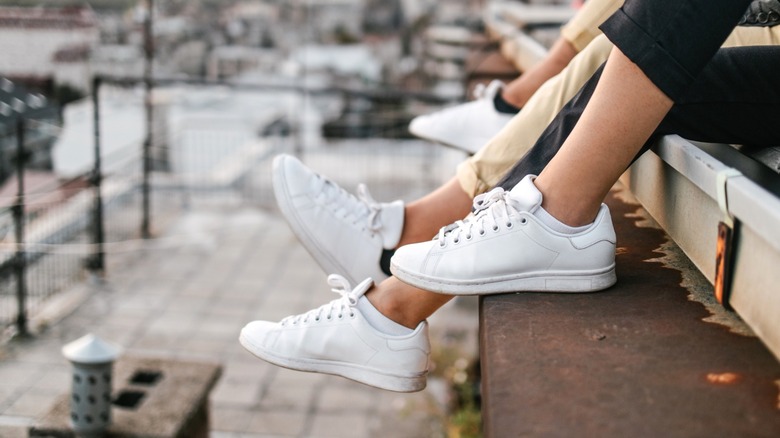 Women wearing white sneakers