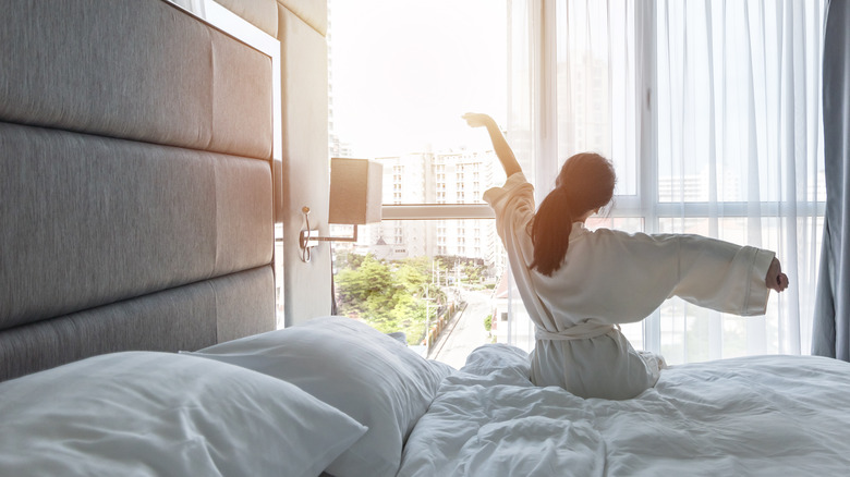 woman waking early in hotel room