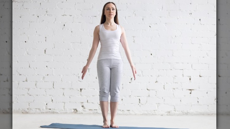 Woman standing in mountain pose 