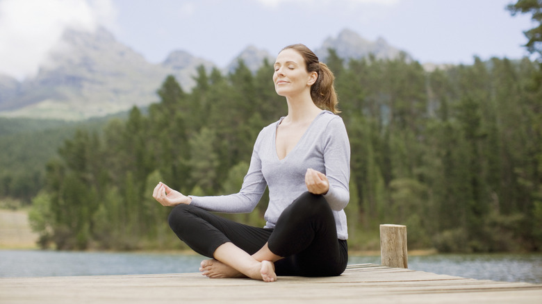 Woman sits in asana pose