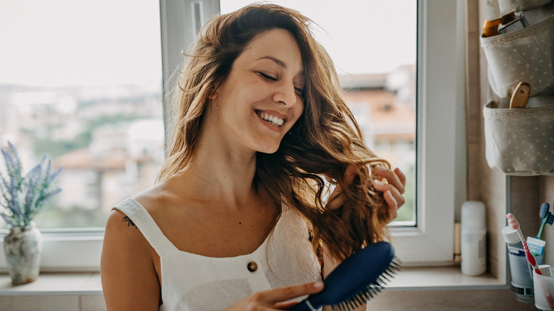 Woman brushing through curls