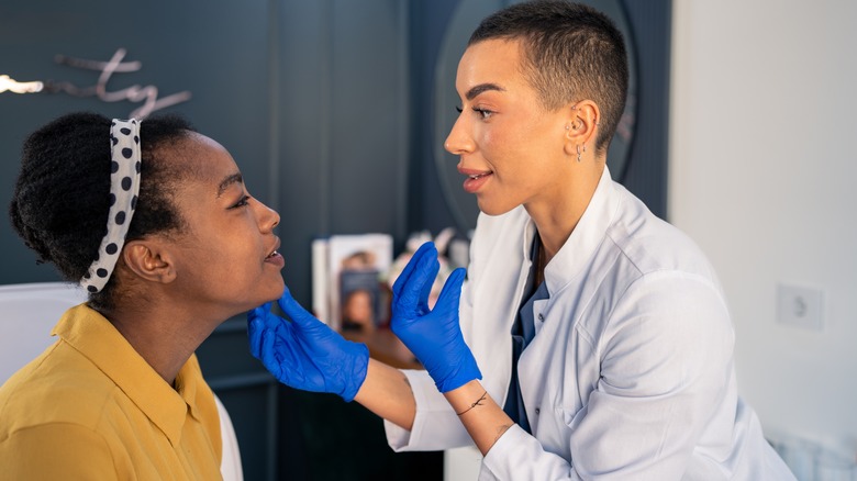 A woman visiting a dermatologist