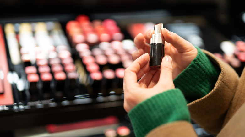 A woman buying lipstick