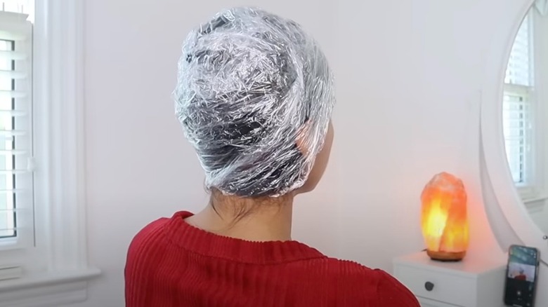 woman with cling wrap on hair
