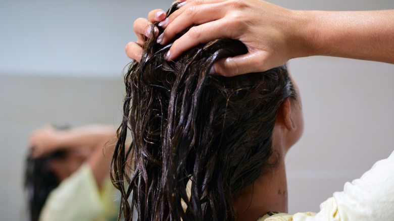 woman applying hair mask