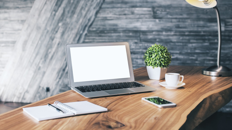 laptop, phone, notebook on desk