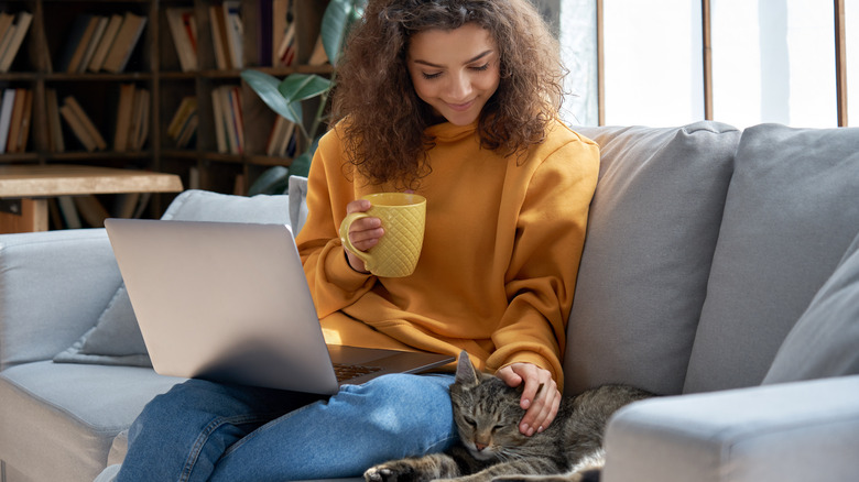 Woman with laptop on couch