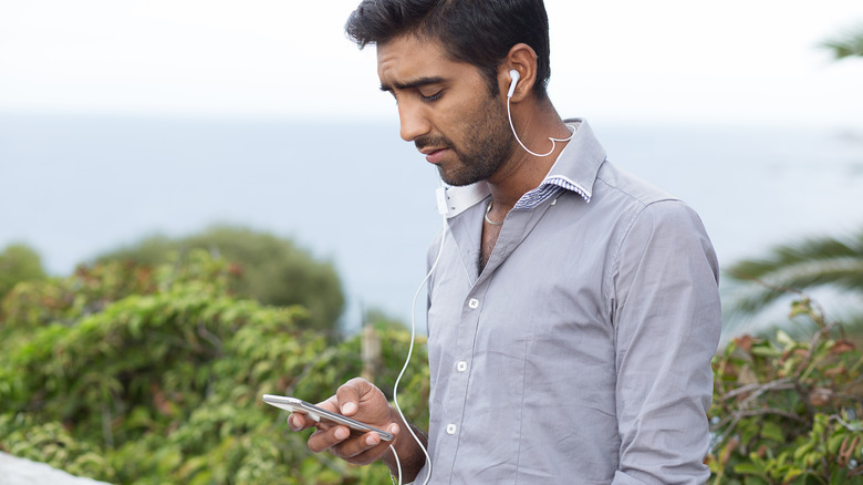 Upset man looking at phone