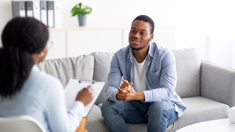 Young man talking to therapist