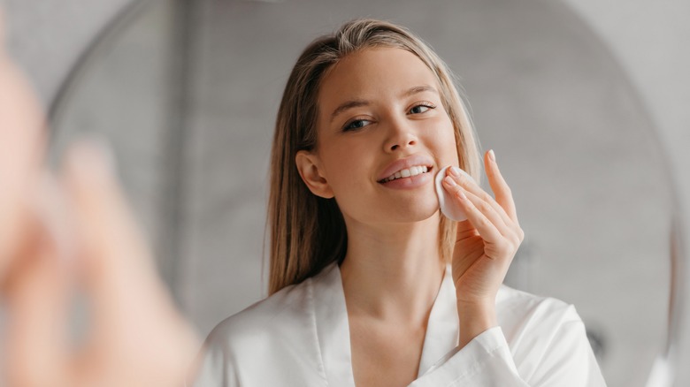 Woman applying skincare