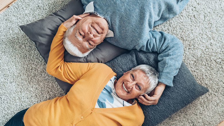 Older couple laying on floor 