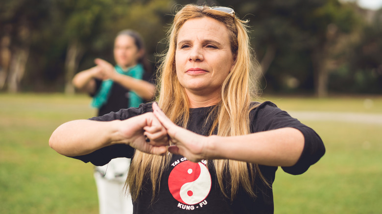 Woman outside with yin and yang symbol on shirt