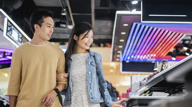 Couple shopping at makeup store