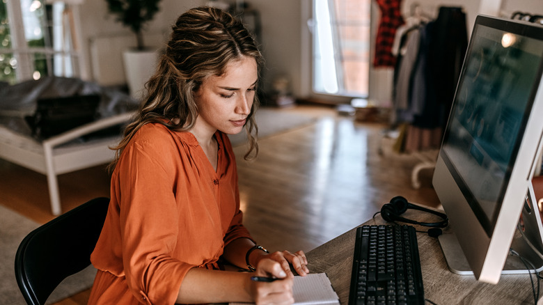 Woman writing a to do list 