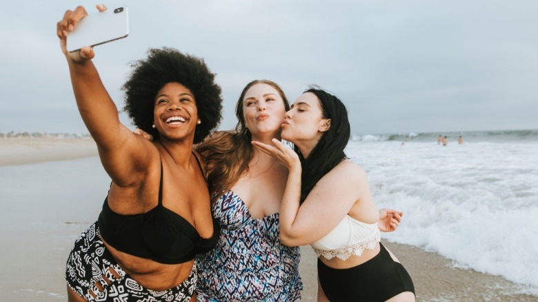 Three women taking swimsuit selfie