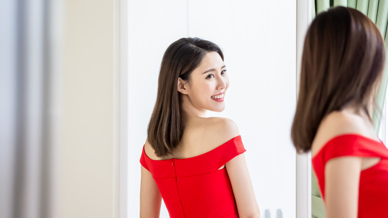 Woman looking at herself in mirror 