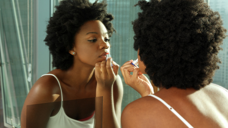 woman applying lip color