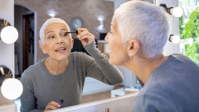 woman applying mascara