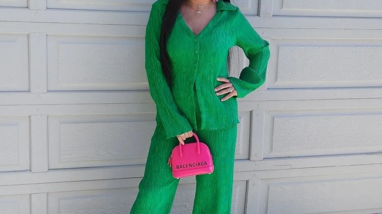 Green outfit and pink purse