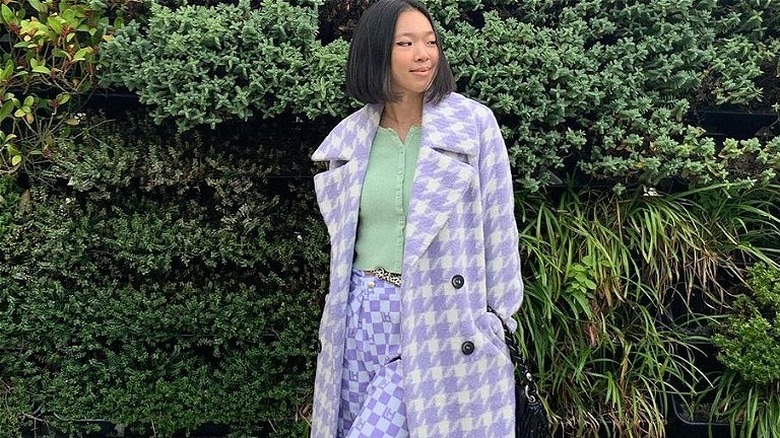 Woman in purple houndstooth outfit