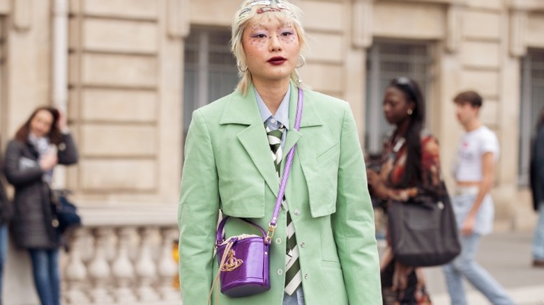 Woman in green suit with purse