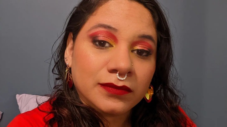 woman wearing red and yellow makeup