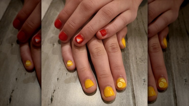 person with red and yellow nails