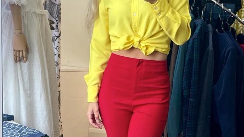 woman in top and red pants