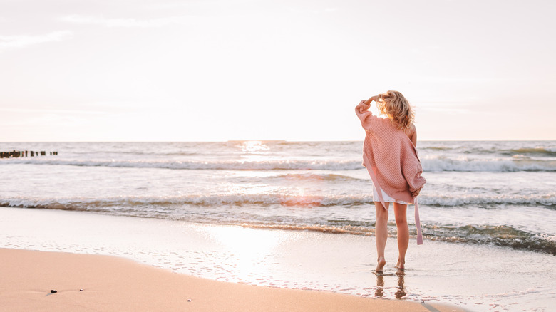 woman in sweater on beach