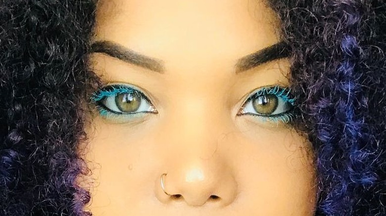 Black girl wearing blue mascara