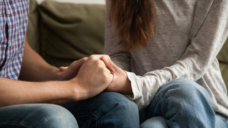 two people holding hands 