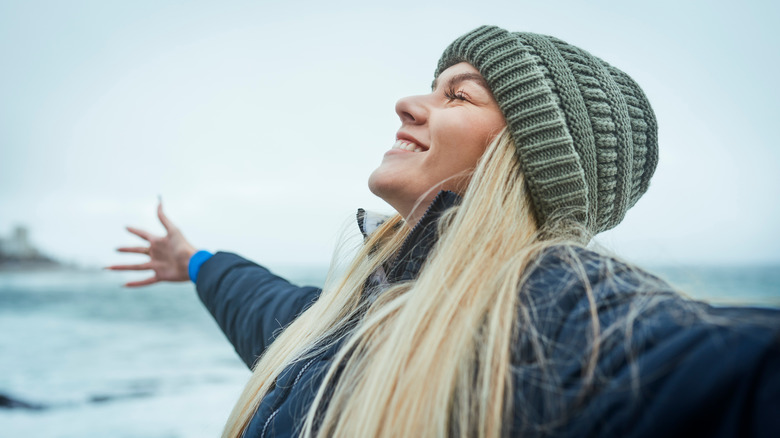 Smiling woman with outstretched arms