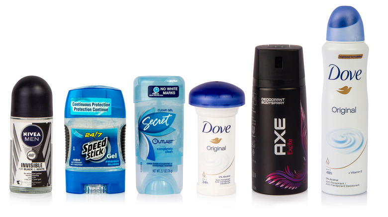 Various deodorants on solid background